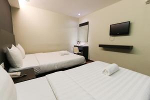 Voodi või voodid majutusasutuse Hotel 99 Bandar Klang (Meru) toas