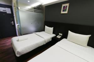Voodi või voodid majutusasutuse Hotel 99 Bandar Klang (Meru) toas