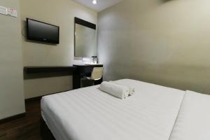 Voodi või voodid majutusasutuse Hotel 99 Bandar Klang (Meru) toas