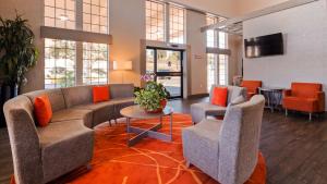 a lobby with a couch and chairs and a table at Colony Inn in Atascadero