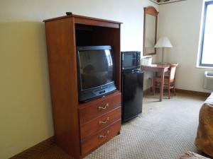 a large wooden entertainment center with a television in a hotel room at Red Carpet Inn Brooklyn in Brooklyn