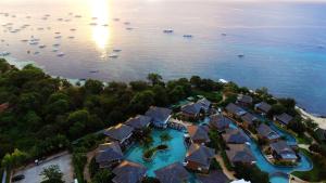 an aerial view of a resort with a beach and boats at BE Grand Resort, Bohol in Panglao