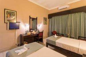 Postel nebo postele na pokoji v ubytování Hotel Coorg International