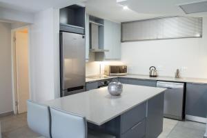 a kitchen with a large island in the middle at 14 Kyalanga - by Stay in Umhlanga in Durban