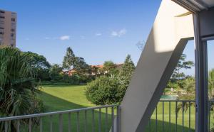 a balcony with a view of a yard at 14 Kyalanga - by Stay in Umhlanga in Durban