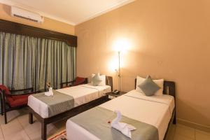 Postel nebo postele na pokoji v ubytování Hotel Coorg International
