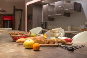 a table with a plate of food on a table in a kitchen at Domaine Jobert in Aubagne