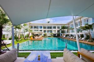 a swimming pool in front of a building at Chi Samui Resort in Bophut