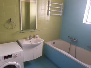 a bathroom with a sink and a washing machine at Vrachati Sea Front House in Káto Ássos +12 photos