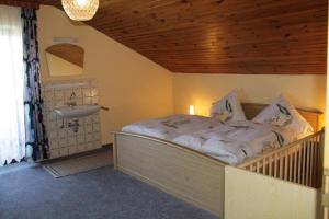a bedroom with a bed and a sink at Ferienwohnung Achatz Josef sen in Arnbruck