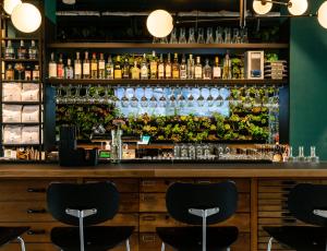a bar with a lot of bottles of wine at Conscious Hotel Westerpark in Amsterdam