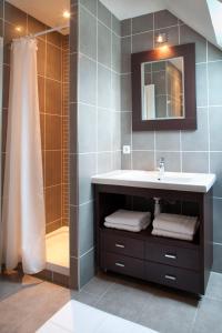a bathroom with a sink and a shower at Le Village Cancalais in Cancale