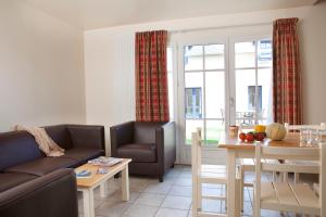 a living room with a couch and a table at Le Village Cancalais in Cancale