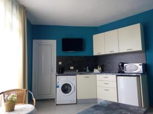 a kitchen with a washing machine and a washer at Aura in Primorsko