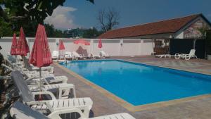 a swimming pool with lounge chairs and umbrellas at Aura in Primorsko