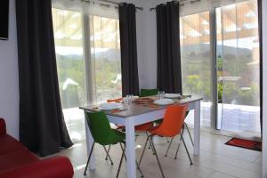 a dining room with a white table and four chairs at Borgo Aranci - Appartamento in Villa Orchidea - 12A in Castellammare del Golfo