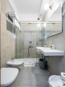 a bathroom with a sink and a shower and a toilet at Hotel Aurora in Milan