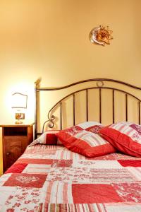 a bedroom with a bed with red pillows on it at Paste Apartment in Venice