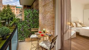 a balcony with a table and chairs on a balcony at Sweet Rooms Piramide Bed and Breakfast in Rome