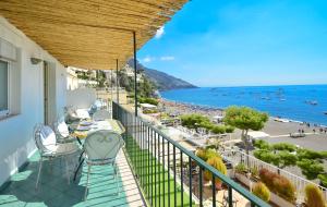 a balcony with a table and chairs and a view of the ocean at AMORE RENTALS - Casa Raffi in Positano