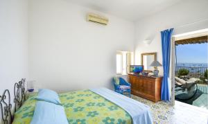 a bedroom with a bed and a desk and a window at AMORE RENTALS - Casa Raffi in Positano