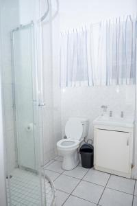 a white bathroom with a toilet and a shower at Seabrook 202 in Margate