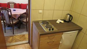a small kitchen with a stove and a table at Beachfront Apartments Oaza in Petrovac na Moru
