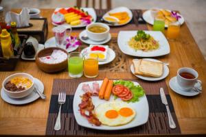 a table topped with plates of breakfast foods and drinks at Chivapuri Beach Resort in Ko Chang