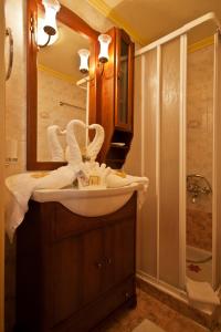 a bathroom with a sink and a mirror and a shower at Casa Leone Hotel in Chania Town