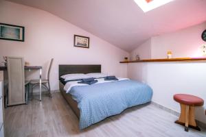 a bedroom with a bed and a desk in it at Apartment Jug in Piran