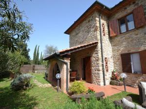 a stone house with a patio in front of it at Belvilla by OYO Villa Max in Suvereto