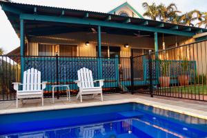 
a pool with chairs and a pool table at Spike the Bubble Beach House in Broome

