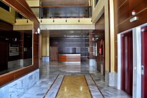 a hallway of a building with a lobby with a floor at WonderStays Apartamentos La Estación in Málaga