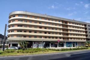 a large building on the side of a street at WonderStays Apartamentos La Estación in Málaga