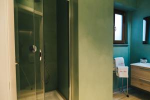 a shower with a glass door in a bathroom at Relais Monti Apartments in Vallo della Lucania +44 photos