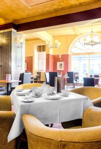 a dining room with a white table and chairs at White Swan Hotel in Alnwick