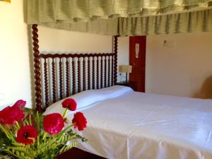 a bed with a flower arrangement on it in front of a window at Hotel Sant Jaume in Alcudia