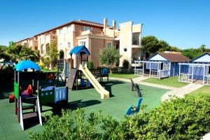 a playground with a slide and a slideintend at Grupotel Club Turquesa Mar in Son Xoriguer