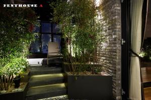 a set of stairs with potted plants next to a building at 9 Brick Hotel in Seoul