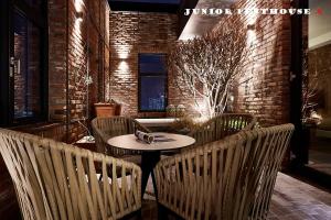 a patio with a table and chairs and a brick wall at 9 Brick Hotel in Seoul