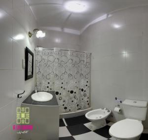 a bathroom with a toilet and a sink and a shower at A la Gurda Hostel - Barrio Norte in San Miguel de Tucumán +28 photos