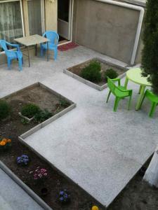 a patio with a table and chairs and flowers at Comfort Plus in Tbilisi City