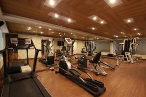 a gym with several exercise bikes and treadmills at Minerva Grand Secunderabad in Hyderabad