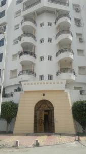 a large white building with balconies on top of it at Residence Ahlem in El Aouina