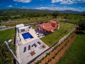 an aerial view of a house with a swimming pool at Vacation house Radosic in Radošić