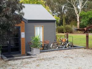 a tiny house with two bikes parked in front of it at Irongate Studio B&B in Mintaro