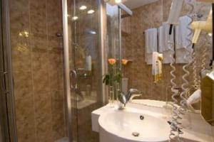 a bathroom with a shower and a sink and a shower at Hotel Alter Speicher in Lübeck