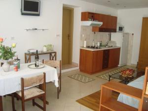 a kitchen and living room with a table and chairs at Studio Apartment Lile in Trstenik