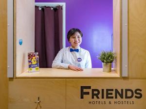 a woman standing behind a counter in a hotel room at Friends on Nevsky in Saint Petersburg