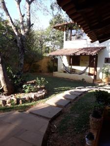 a house with a walkway leading to a yard at Pousada Por do Sol in Sao Jorge